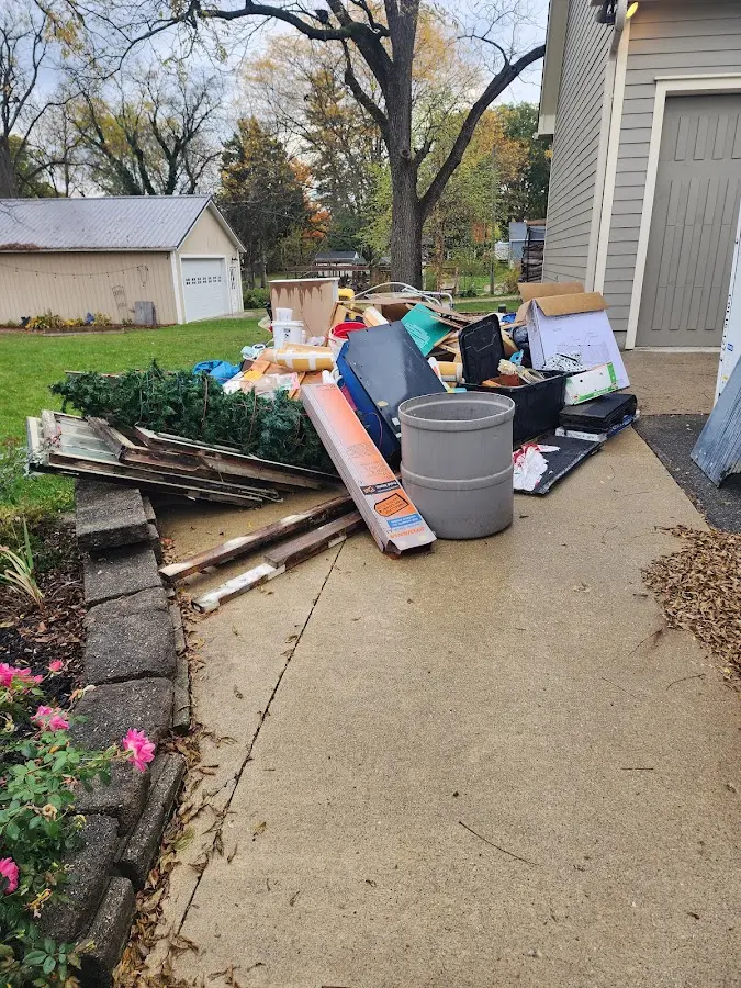 Dumpster being loaded with debris for Estate Cleanout Dumpster Rental in Riverdale